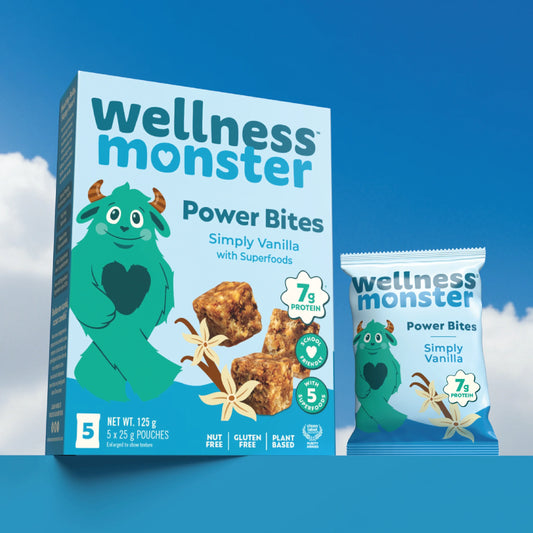 Wellness Monster Simply Vanilla Power Bites box and individual pouch on a blue platform against blue sky background